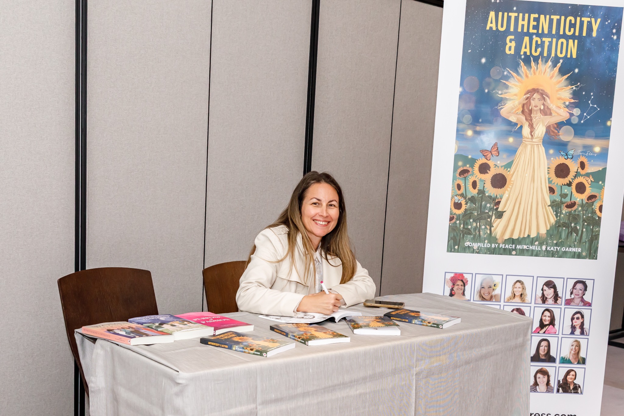 Tanya Hicks signing a book at the Authenticity & Action launch